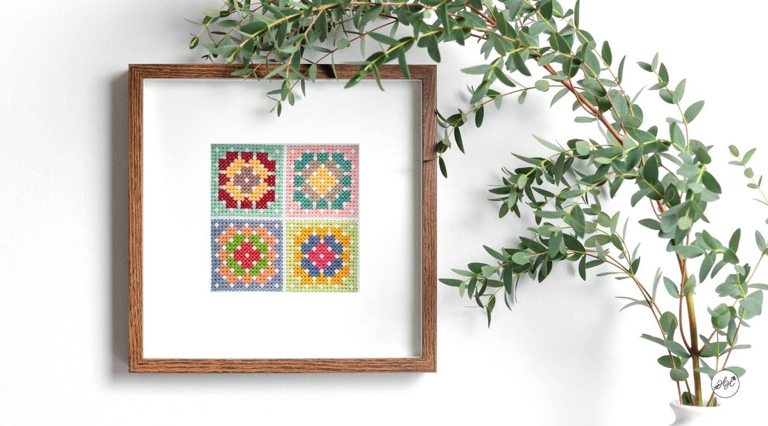 Framed Cross Stitch next to Green Plant