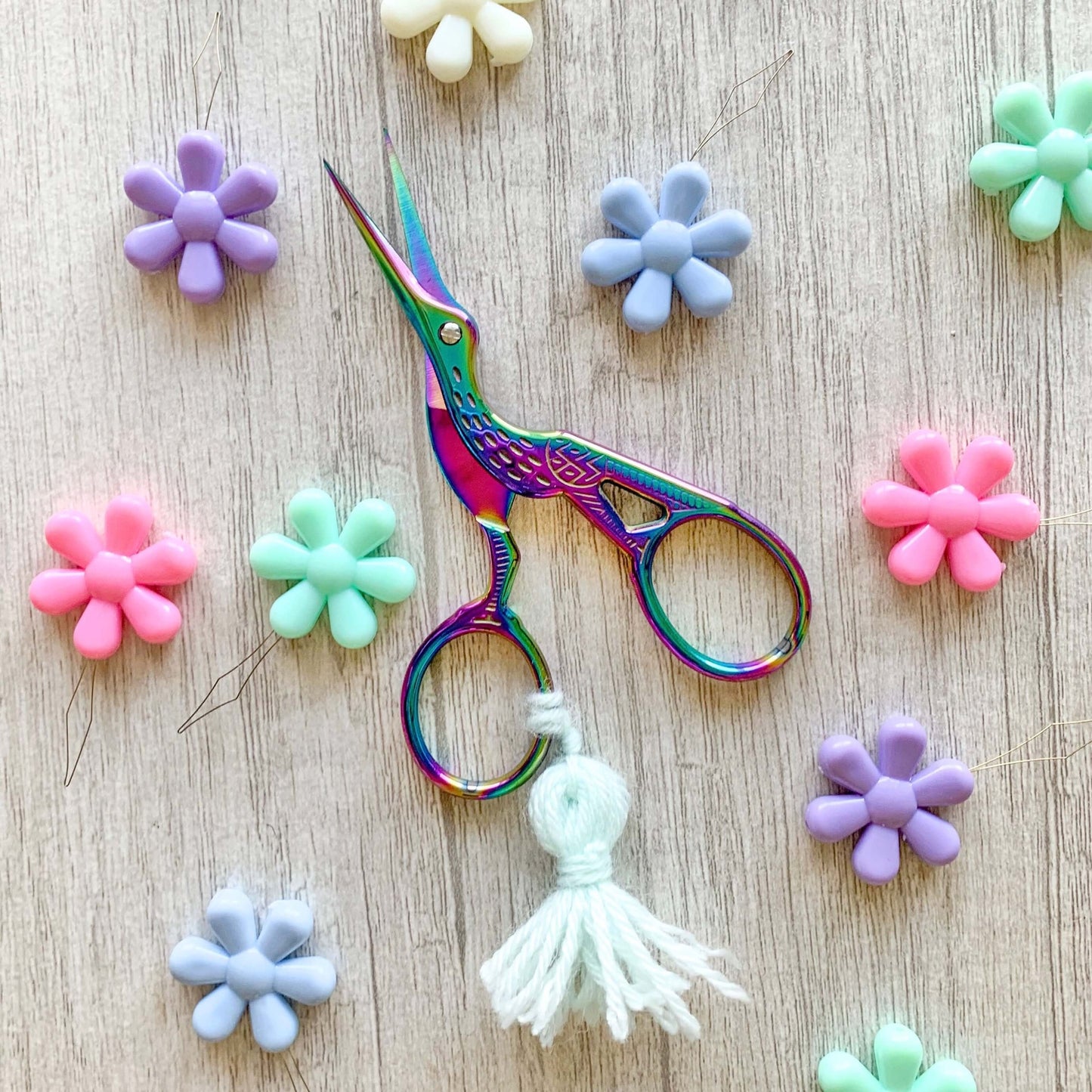 Iridescent bird embroidery scissors with a blue tassel
