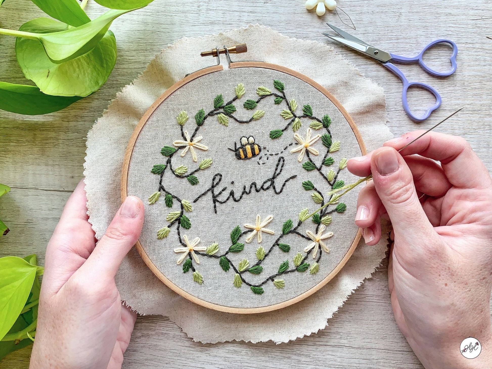 Woman embroidering a bee embroidery pattern