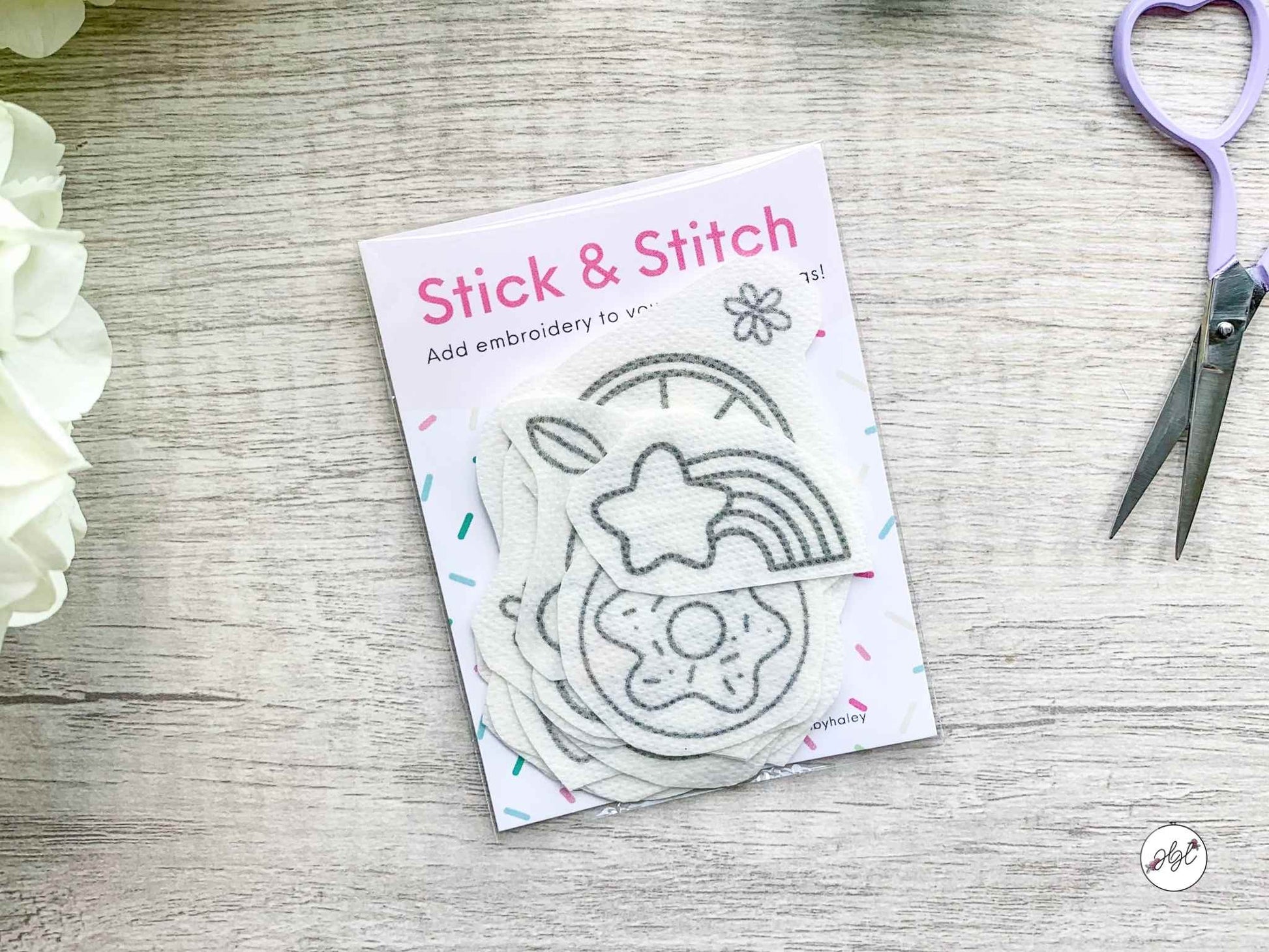 Kawaii stick and stitch embroidery designs in cute patterns next to embroidery scissors and hydrangeas