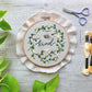 Bee embroidery hoop kit next to embroidery floss and craft scissors
