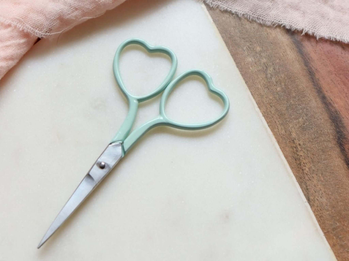 Heart shaped embroidery scissors in a mint green color