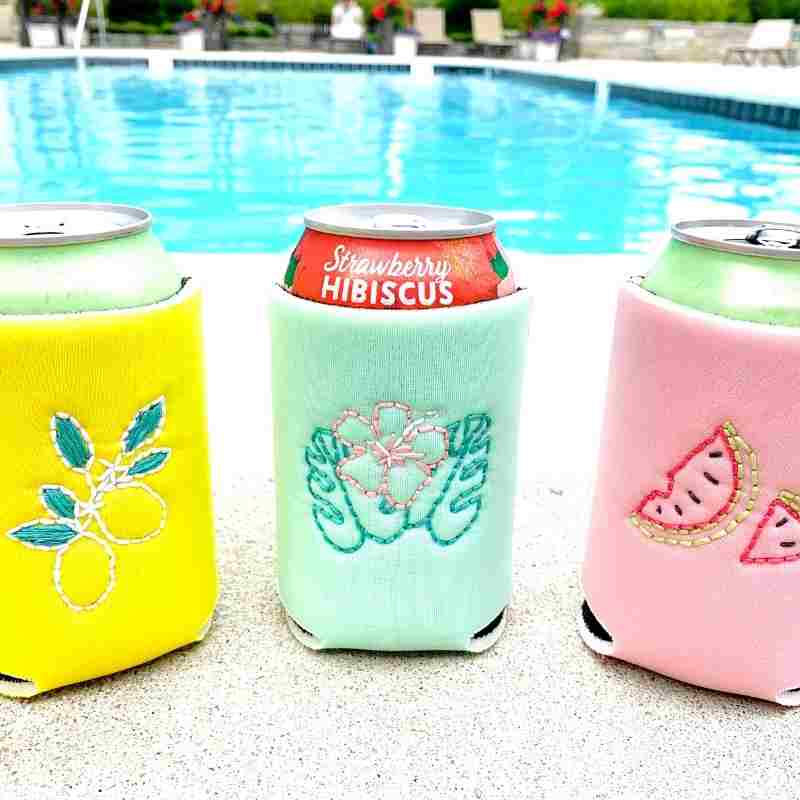 hand embroidered drink coolers by the pool in yellow, green, and pink